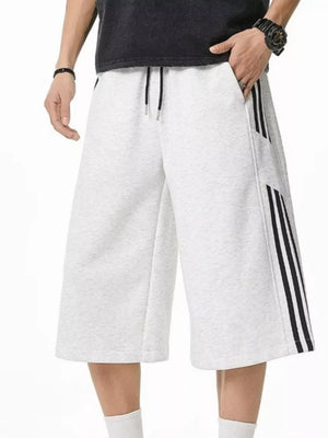 Grey sweatpants with drawstring and black side stripes