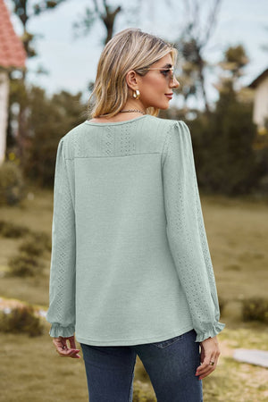 Sage waffle knit blouse with perforated details and ruffled cuffs