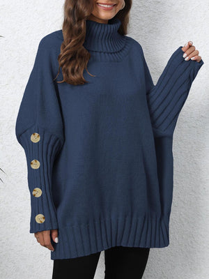 Dark blue turtleneck sweater with button cuff detail and ribbed trim.