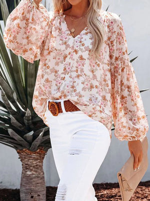 Floral print V-neck long sleeve maternity shirt with balloon sleeves.