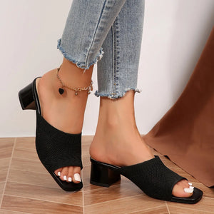 Black knit block heel mules with open toe and square toe.