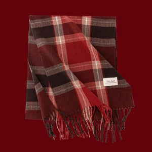 Cozy plaid scarf in red, brown, and cream with fringe details.