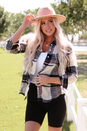 Linen plaid button-down overshirt with white and navy checks, worn open over a white tank top.