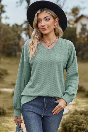 Light Green textured cable knit V-neck pullover sweater with long sleeves.