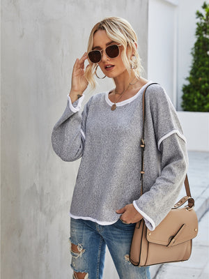 Off-shoulder knit pullover sweater in dark gray with white trim, casual boat neck style.