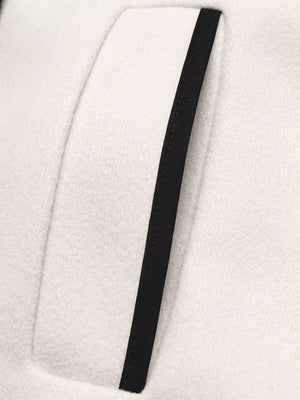 Beige bolero jacket with black contrast trim detail on pocket
