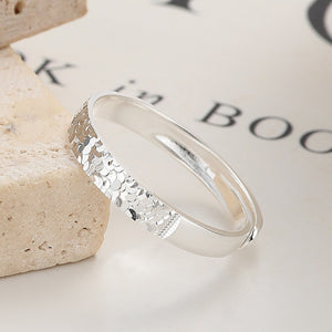 Textured sterling silver ring with a hammered scale pattern