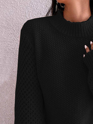Black textured knit sweater with mock neck and puff sleeves