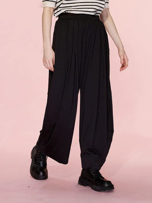 Black pleated drape palazzo trousers with wide leg and elastic waist.