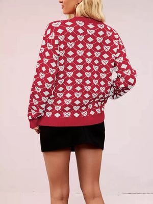 Red argyle knit sweater with white hearts and diamonds pattern, crew neck, long sleeves.