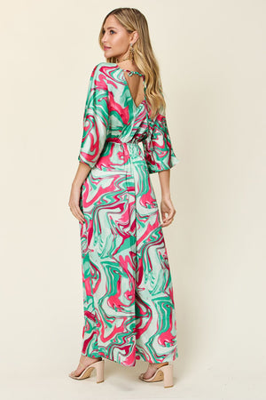 Green swirl print kimono sleeve jumpsuit with open back detail.