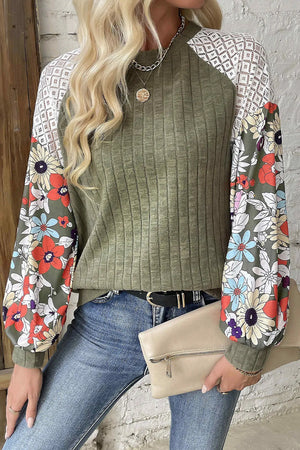 Moss green ribbed blouse with floral print sleeves and white lace yoke.