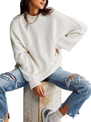 White oversized ribbed knit sweater with drop shoulders and mock neck.