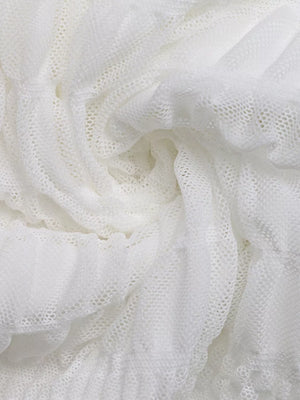 White textured smocked dress fabric with a deep v-neck detail