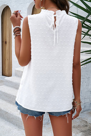 White textured yoke dot tank top with ruffled mock neck and tie back detail.