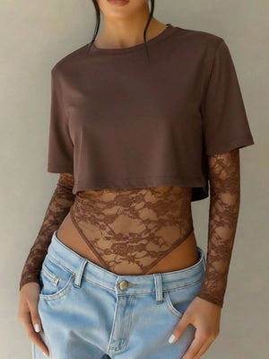 Brown lace bodysuit with sheer long sleeves and patchwork detail, worn with a cropped brown top.