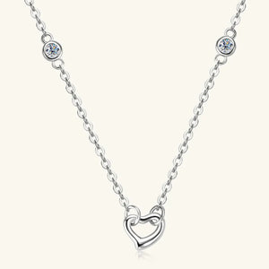 Silver linked heart pendant necklace with bezel-set crystal accents.