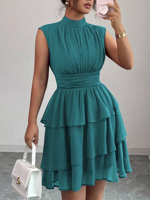 Sleeveless teal ruffled tiered dress with ruched bodice and mock neck.