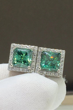 Green square stud earrings with halo of small diamonds.