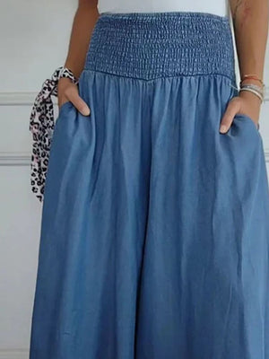 Smocked waistline flow trousers in dusty blue with pockets.