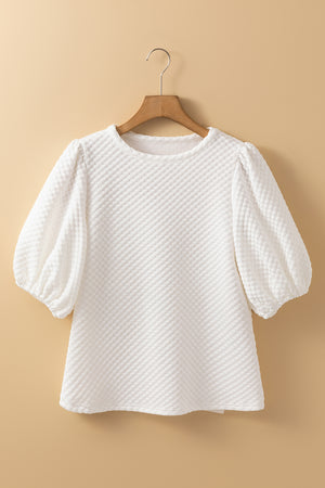 White textured quilted blouse with puff sleeves and round neckline