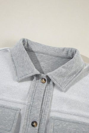 Light gray cotton utility vest with contrast trim and button-down front.