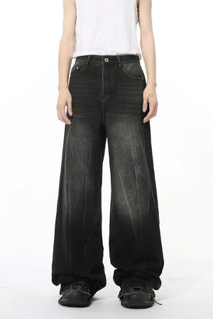 Dark wash wide leg jeans with a relaxed fit and faded details.