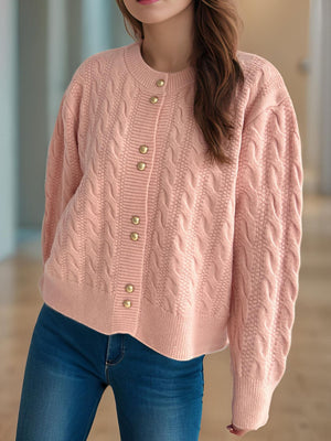 Dusty pink cable knit cardigan with puff sleeves and gold buttons.