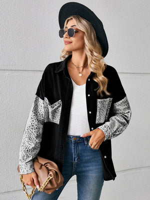 Black denim overshirt with leopard print sleeves and buttoned pockets.
