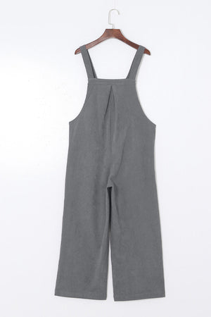 Corduroy overalls in dark gray with wide leg silhouette and buttoned straps.