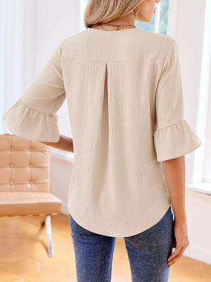 Apricot maternity shirt with 3/4 bell sleeves and cascading ruffles.
