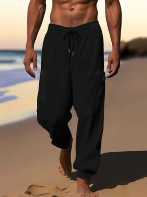 Black waffle knit joggers with drawstring and cargo pockets.