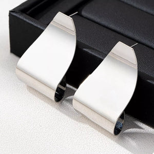Silver alloy geometric earrings with a bold, curved design.
