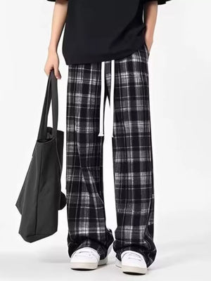 Plaid drawstring sweatpants in black and white with a relaxed fit.