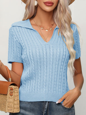 Light blue cable-knit short sleeve polo sweater with a V-neck.