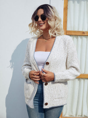 Textured knit cardigan in white with contrast trim and button front.