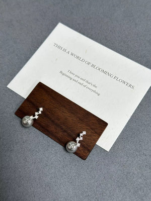 Elegant sterling silver drop earrings with gray pearls and zircon accents.