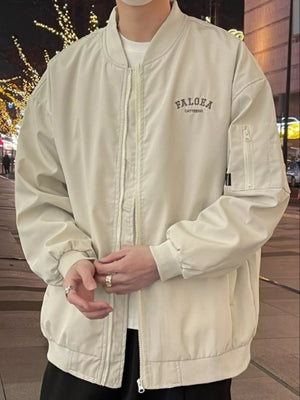 Apricot bomber jacket with zip front, chest logo and zippered sleeve pocket.