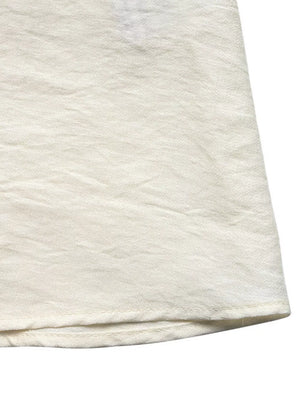 Beige maxi dress hem detail with textured fabric and subtle crinkles.