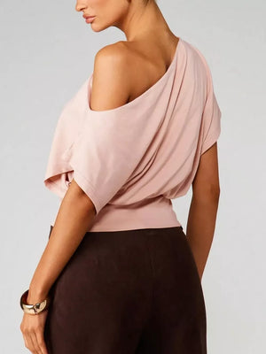 Pink asymmetrical crop t-shirt with draped fit and short sleeves.