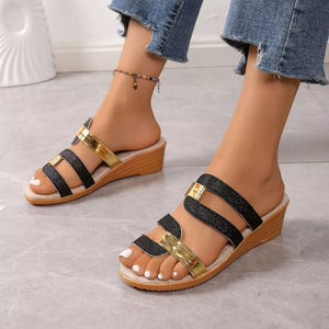 Black glitter and gold dual-strap wedge sandals with open toe and cork wedge heel.