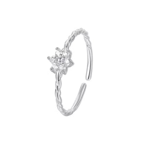 Sterling silver ring with twisted band and a delicate zircon flower detail.