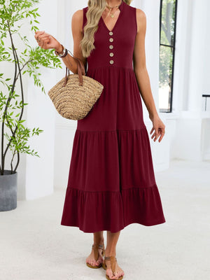 Burgundy tiered midi dress with notched V-neck and decorative buttons.