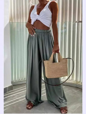 Green maternity paperbag waist pants with adjustable fit and wide legs.