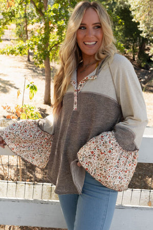 Mocha floral bell sleeve henley top with contrast panels and button neckline.