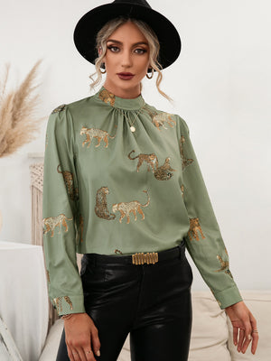 Matcha green leopard print blouse with keyhole neck and long sleeves.