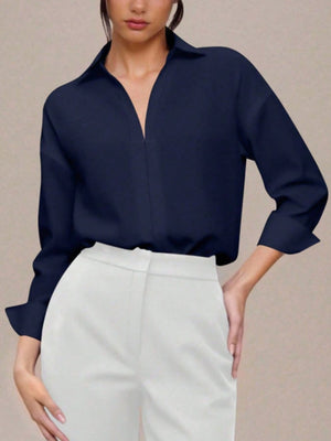 Navy blue long sleeve collared bodysuit with a deep V-neckline.