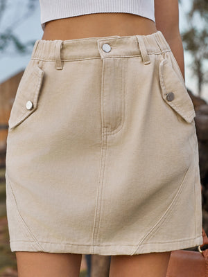 Tan utility pocket mini skirt with elastic waist and button details.