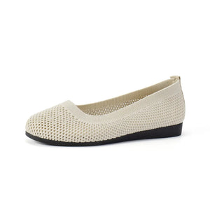 Beige breathable knit ballet flats with a round toe and flexible sole.
