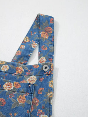 Floral denim overalls with adjustable straps and button detail.